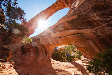 A father with his baby son near Double O arch in Arches National Park in Utah, USA