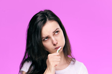 Fototapeta premium toothbrush, morning procedures, woman on a pink background