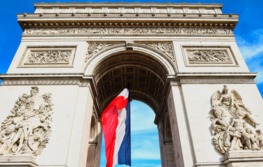 Fototapeta premium The Triumphal Arch decorated with French flag, Paris, France