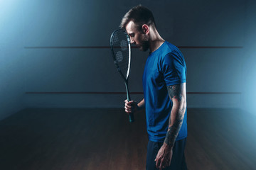 Squash game concept, male player with racket © Nomad_Soul