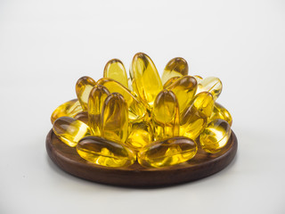 fish oil on wooden isolated on white background