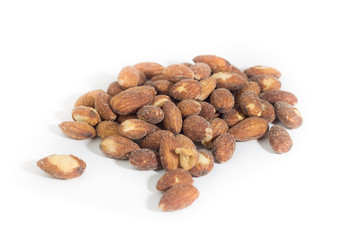 Salted and roasted almonds on white background
