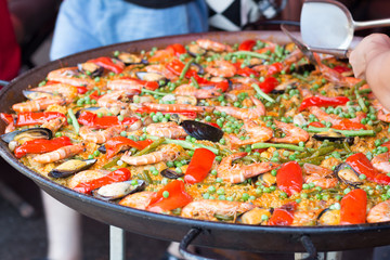 Traditional spanish rice paella with seafood. Mixed seafood stir fried spicy and salad
