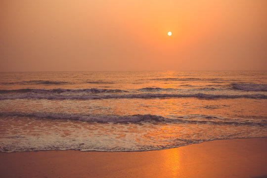 Colorful sunset over the ocean Vagator Beach, south Goa, India. © Mariiam