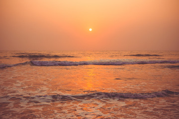 Colorful sunset over the ocean Vagator Beach, south Goa, India.