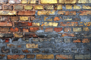 The texture of an old brick crumbling wall of yellow  bricks with plaster.