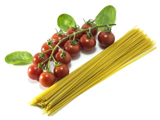 Cherry tomatoes with dry Italian pasta on a white background.