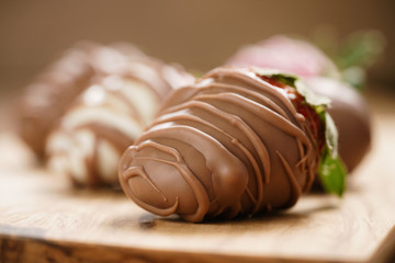 chocolate covered strawberries on wood board