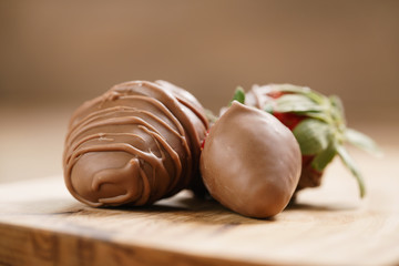chocolate covered strawberries on wood board