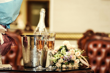 wedding decoration with two glasses of champagne on ceremony,wedding bouquet and two glasses with champagne