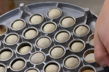 The process of making dumplings in the kitchen.