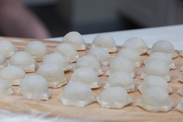Fototapeta na wymiar The process of making dumplings in the kitchen.