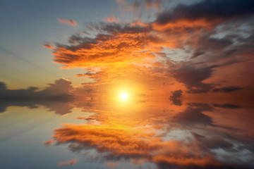 Fototapeta na wymiar Cumulus sunset clouds with sun setting down