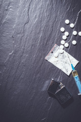 Overhead shot of hard drugs on gray stone table