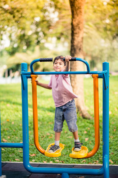 Little Boy Playing At Outdoor Gym In The Park
