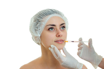 Portrait of a cute young girl in medical CAP which the doctor inserts a vaccine on the face closeup