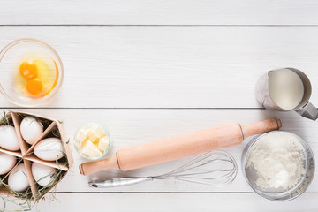 Baking ingredients on white rustic wood background, copy space