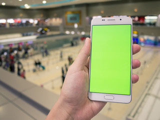 A man holding smartphone with green keyed out screen