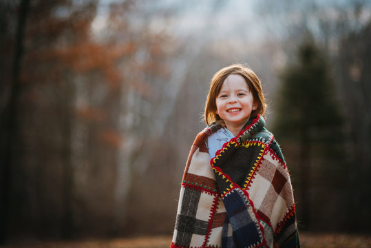Portrait of a girl wrapped in a patchwork quilt