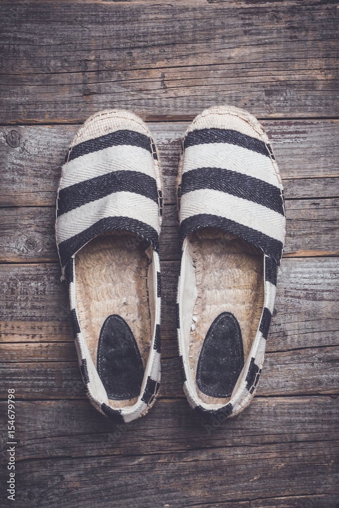 Wall mural espadrilles on wooden background