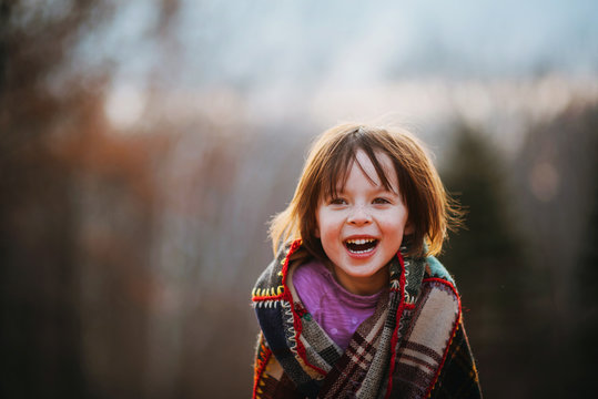 Portrait of a girl wrapped in a patchwork quilt