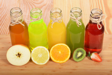 Fototapeta na wymiar Colorful fruit juices in glass bottles for a healthy breakfast
