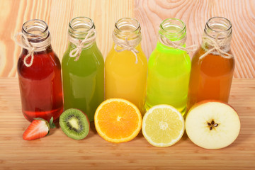 Colorful fruit juices in glass bottles for a healthy breakfast