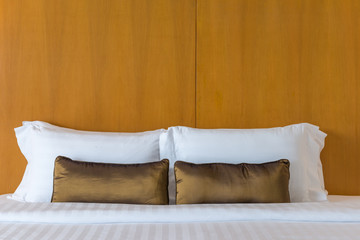 Modern white and brown pillow on a the bed