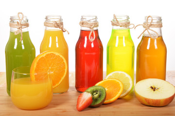 Colorful fruit juices in glass bottles for a healthy breakfast