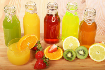 Fototapeta na wymiar Colorful fruit juices in glass bottles for a healthy breakfast