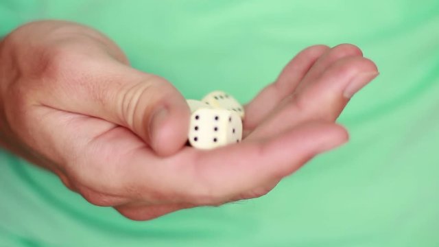 White dice in hand closeup