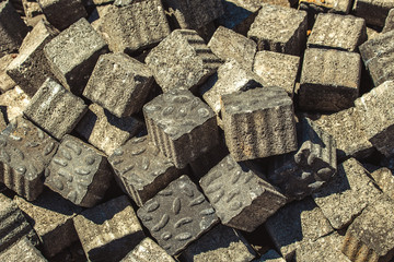A bunch of bricks for a sidewalk or a footpath like a background or wallpaper. Of the decorative stones laid paved path and patterns on it.