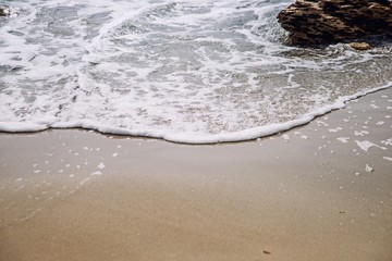 Beach with yellow sand, big rocks and beautiful waves, ocean beach, sea beach
