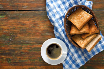 Breakfast background, toast and coffee on rustic wood, top view