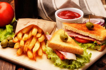 Freshly clubsandwiches with sauce and french fries