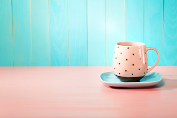 Coffee mug on bright pink and blue background