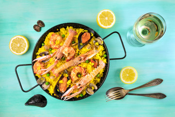 Spanish seafood paella with white wine and copyspace