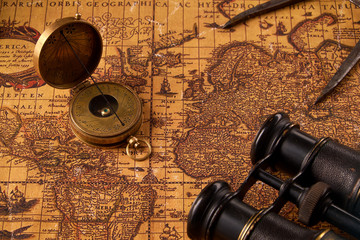 Old vintage retro compass on ancient world map. Vintage still life. Travel geography navigation...