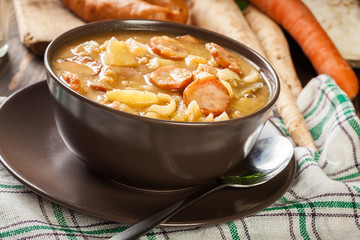 Traditional Polish split pea soup with sausage, bacon and potatoes