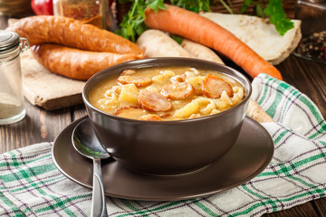 Traditional Polish split pea soup with sausage, bacon and potatoes