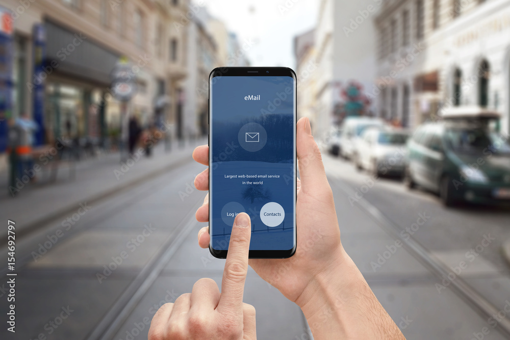 Poster Man use email app on mobile phone. Modern smart phone with round edges and flat user interface design. Street in background.