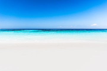 Fototapeta na wymiar Beautiful tropical beach, white sand and blue sky background.