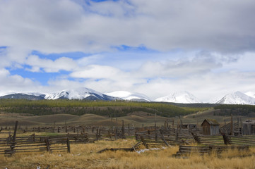 Abandoned Ranch Against Snow Covered Mountain Backdrop