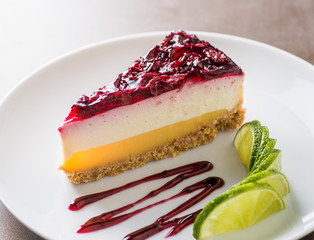 piece of cheesecake served on a white plate with a cup of coffee