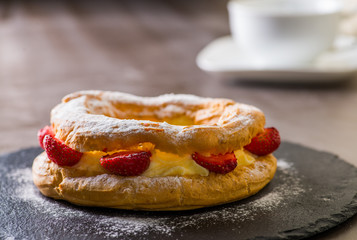 custard cake with strawberries and a cup of coffee