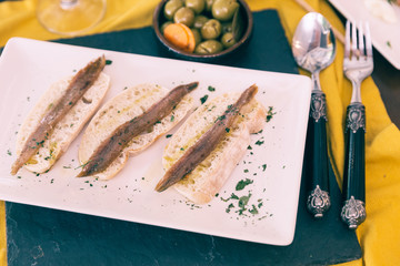 Tapas with sliced bread and fish