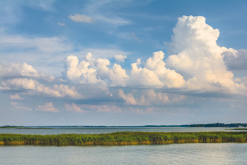 clouds on the blue sky gathering over the lake