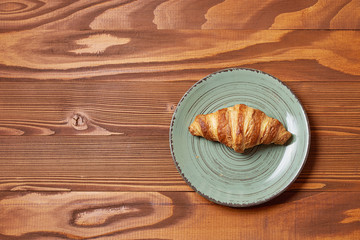 Food plate of croissant  on wooden background
