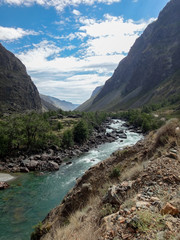 landscape of river in wild nature with mountains at horizon