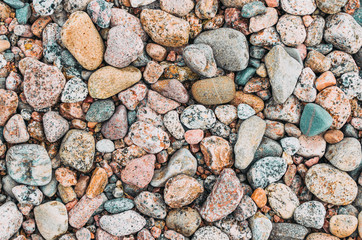 Background texture of round granite beach stones.